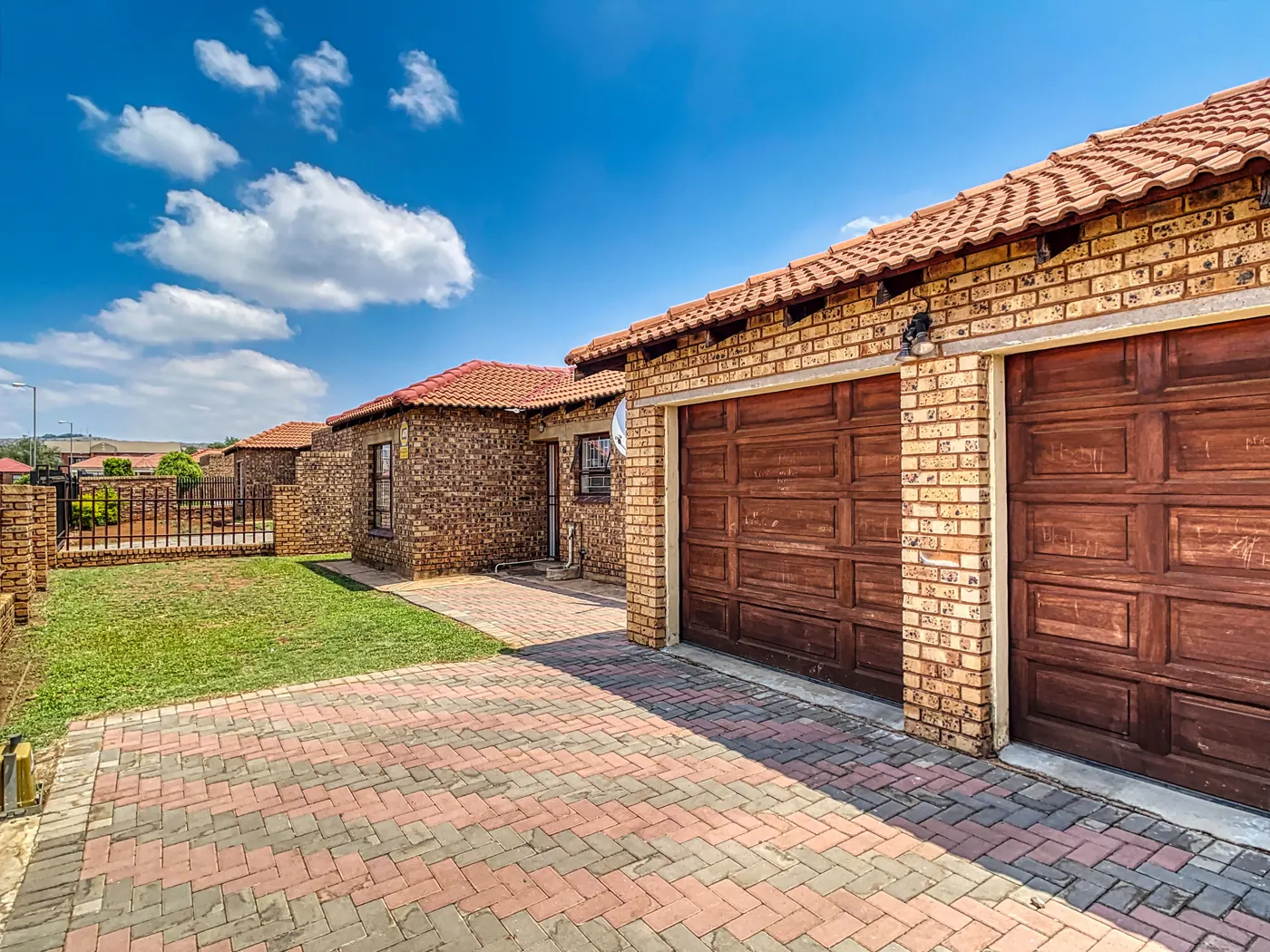 South African residential home with a double garage and paved driveway